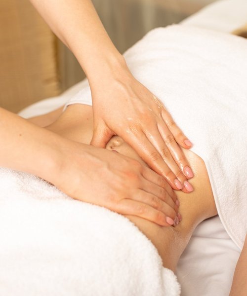Manual lymphatic drainage massage on the abdomen at Ella Beauty Skin Care in Newark, NJ
