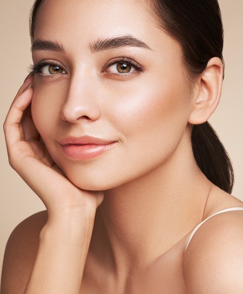 Woman with radiant, healthy skin after professional skincare treatment